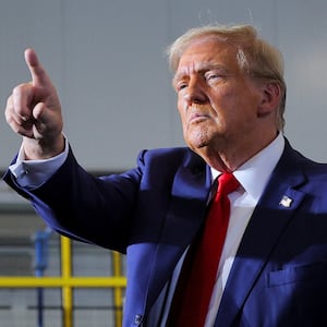 Donald Trump gestures as he makes a campaign stop at manufacturer FALK Production in Walker, Michigan.