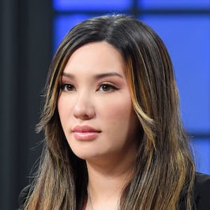 Lauren Chen stares forward on a TV set.