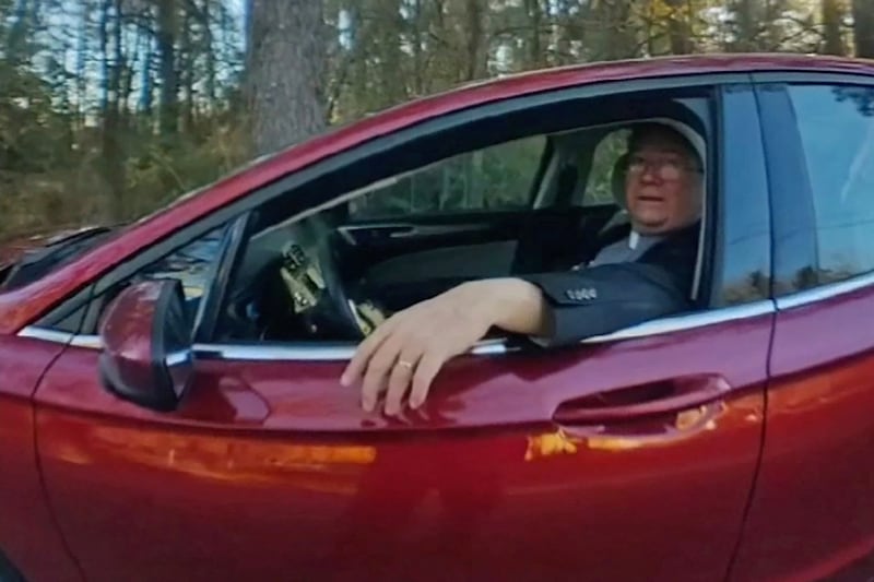 A still from police bodycam footage showing Rev. Stephen Lee being questioned outside of Ruby Freeman’s home.