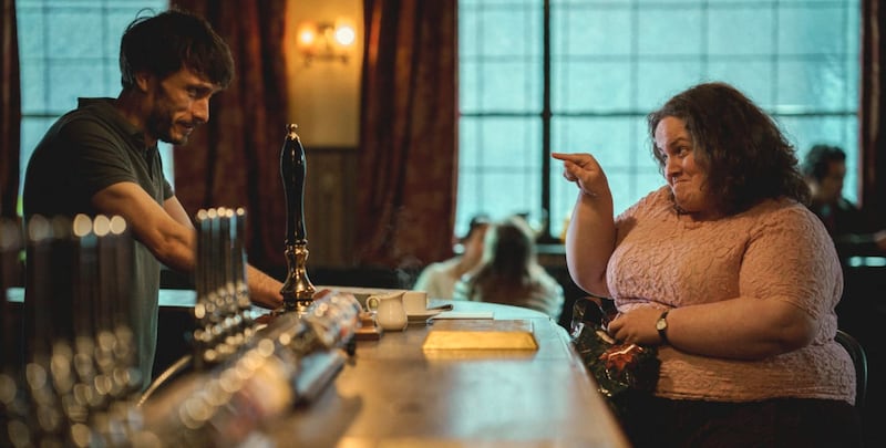 A scene from Baby Reindeer: Martha points at Donnie Dunn across the bar