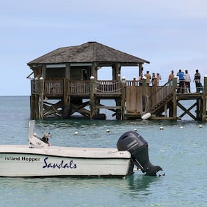 People gather on the resort pier after what police described as a fatal shark attack against a tourist at Sandals Royal Bahamian resort, in Nassau, Bahamas December 4, 2023.  