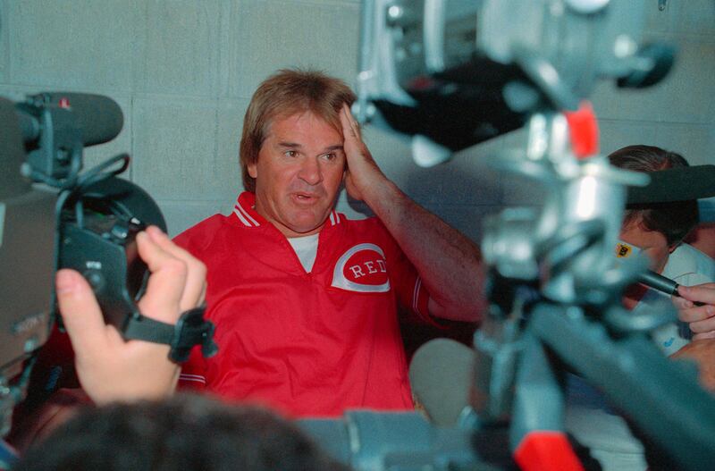 Reds manager Pete Rose holds an impromptu press conference in the dug out prior to their game against the St. Louis Cardinals, during the middle of an investigation by the baseball commissioners’ office into his alleged gambling.