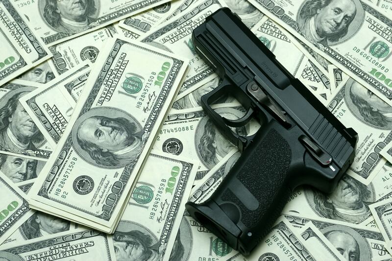 articles/2014/04/18/money-and-guns-how-we-escape-our-existential-dread/140417-poulos-guns-money-tease_odrvof