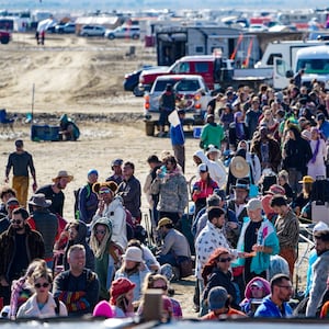 Hundreds of Burning Man attendees who planned to leave on buses wait for information about when they will be able to leave on Labor Day, after a rainstorm turned the site into mud September 4, 2023.