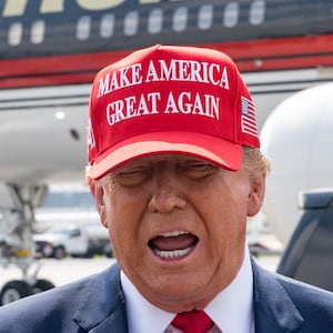 Former U.S. President Donald Trump speaks to the media as he arrives at the Atlanta Airport.