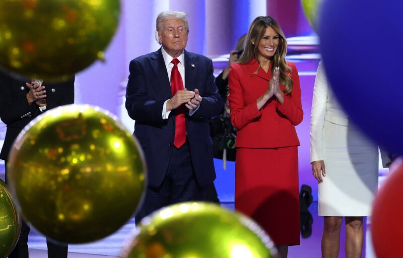 Donald Trump stands next to Melania on stage