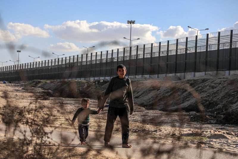 A photo shows people walking on a road near the Gaza border with Eypt.