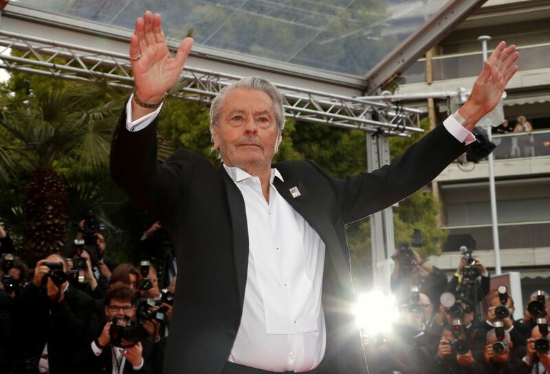 Alain Delon poses before receiving his honorary Palme d'Or Award at the 72nd Cannes Film Festival in 2019.