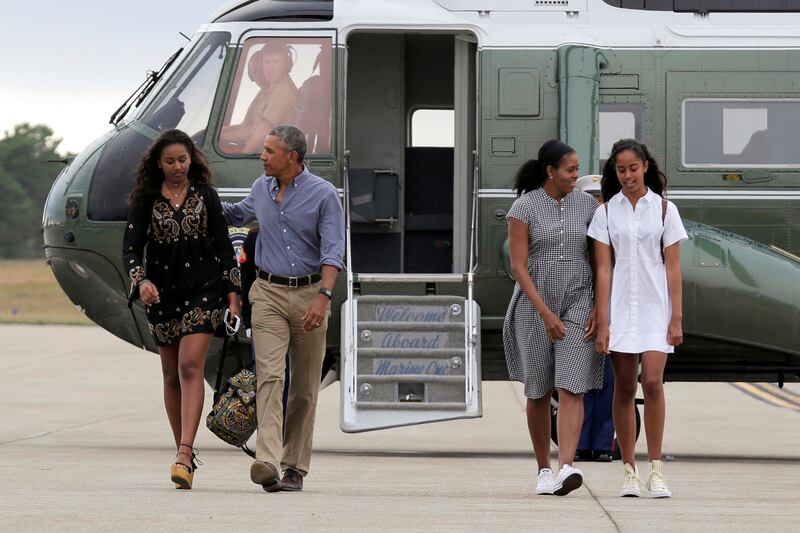 The Obama family walks away from Marine One together.