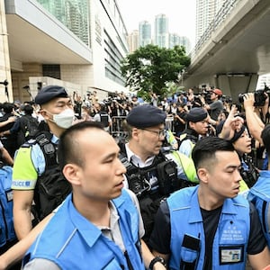 Police try to control media personnel outside the West Kowloon Magistrates’ Court in Hong Kong on May 30, 2024. 