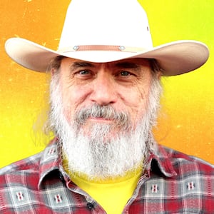 Photo illustration of Larry Charles on a yellow and orange background.