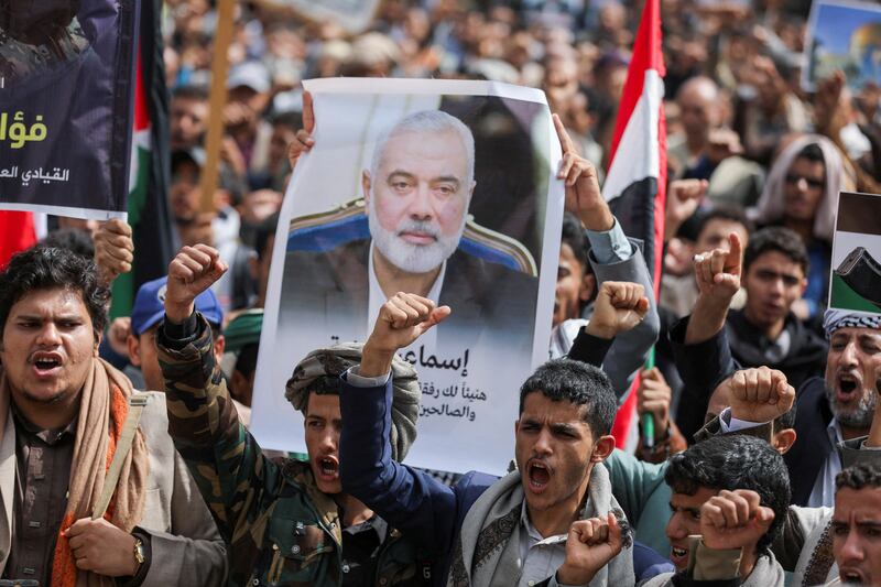 A demonstrator holds up a poster of assassinated Hamas chief Ismail Haniyeh outside the United Nations offices in Sanaa, Yemen.