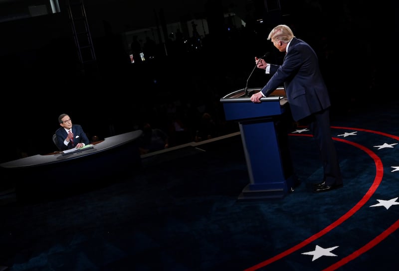 U.S. President Donald Trump speaks to moderator and Fox News anchor Chris Wallace (L) as he debates Democratic presidential candidate Joe Biden at Case Western Reserve University in Cleveland, Ohio, U.S., September 29, 2020. Olivier Douliery/Pool via REUTERS     TPX IMAGES OF THE DAY