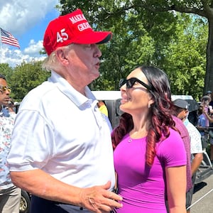 Donald Trump and Laura Loomer stand close and chat with one another at the LIV Golf Tournament in August 2023.