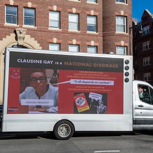 A truck calling the president of Harvard a disgrace drives around Harvard University in Cambridge, Massachusetts.