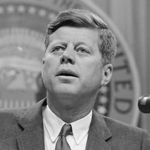 President John F. Kennedy speaking at a conference.