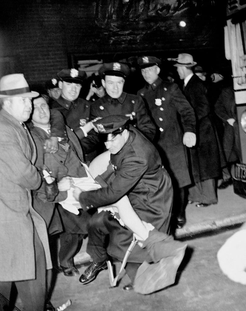 Police arrest Isidore Greenbaum during a Nazi meeting at Madison Square Garden.