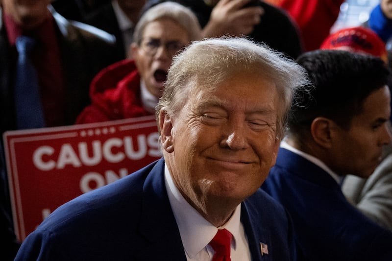 Former President and Republican presidential candidate Donald Trump rallies with supporters at a "commit to caucus" event at a Whiskey bar in Ankeny, Iowa.