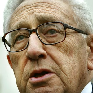 Former U.S. Secretary of State Henry Kissinger speaks to the news media after U.S. President George W. Bush named him to head a panel that will investigate the September 11 attacks, Nov. 27, 2002, at the White House.