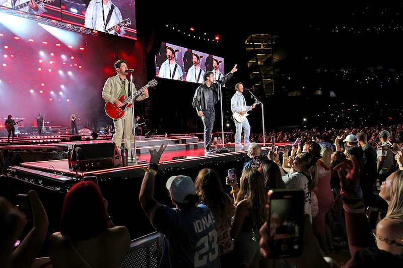 Nick Jonas, Joe Jonas, and Kevin Jonas perform during Jonas Brothers “Five Albums, One Night” Tour in NYC.