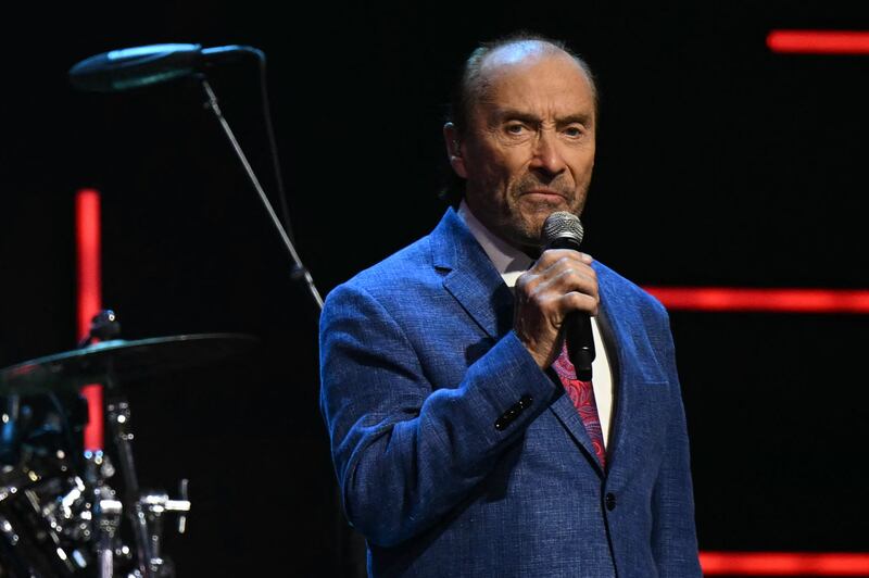 Lee Greenwood holding a microphone