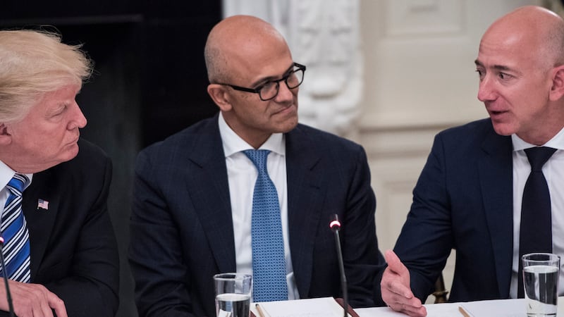 Donald Trump speaks with Satya Nadella, Chief Executive Officer of Microsoft, and Jeff Bezos, Chief Executive Officer of Amazon.