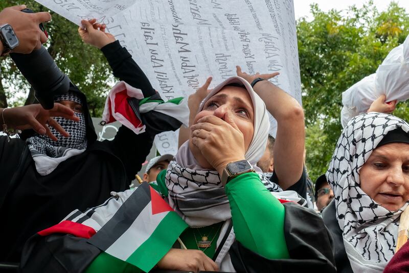 A photo including a protester weeping 