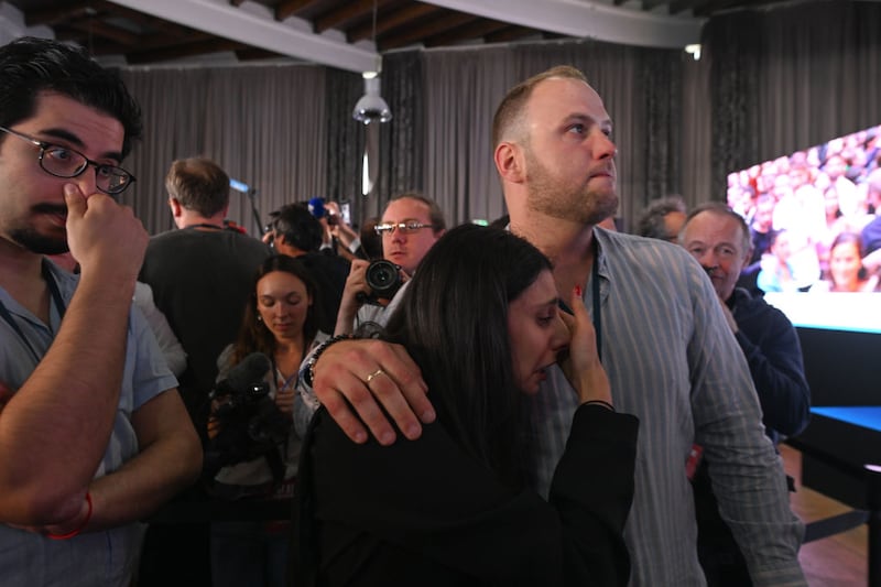 Young supporters of the far-right National Rally party react to results of the second round of the French parliamentary elections Sunday. 