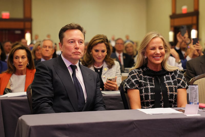 Tesla CEO and X owner Elon Musk sits with Kelly Johnson as U.S. President-elect Donald Trump meets with House Republicans on Capitol Hill in Washington, U.S., November 13, 2024.