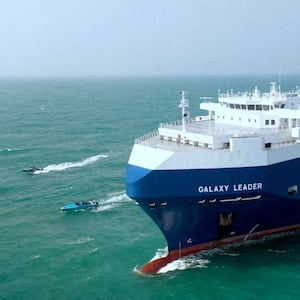 The Galaxy Leader cargo ship is escorted by Houthi boats in the Red Sea in November 2023.