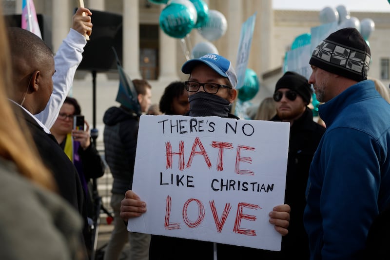 A photo of Lorie Smith and Protesters in front of SCOTUS, Supreme Court of The United States