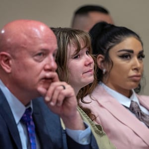 Hannah Gutierrez-Reed, seated between her lawyers, stare forward in court.