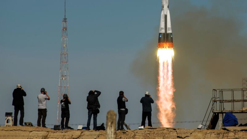 onlookers in kazakhstan watching soyuz rocket take off