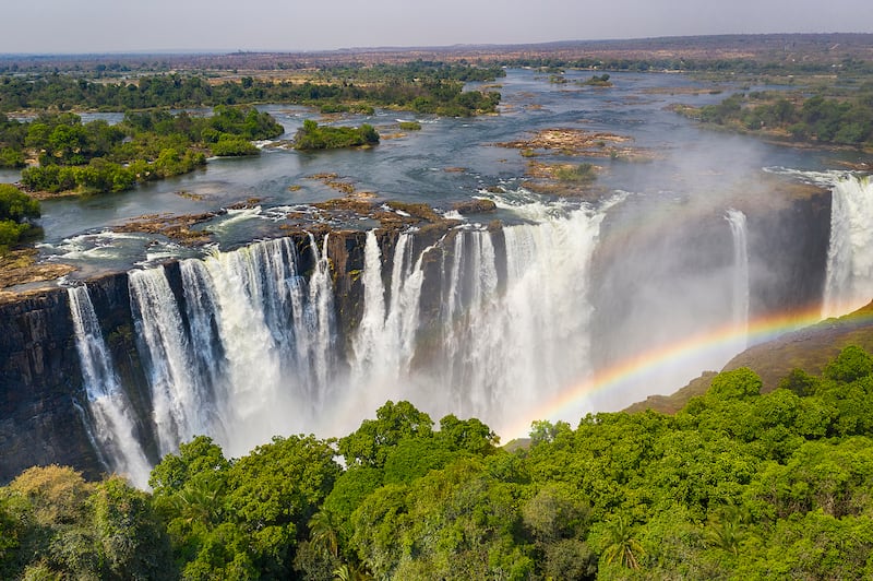 Aerial view of Victoria Falls with a large rainbow