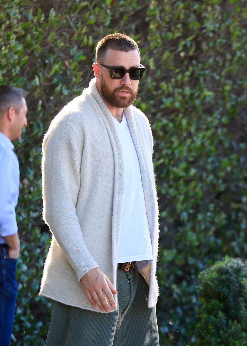 Travis Kelce in a grey cardigan