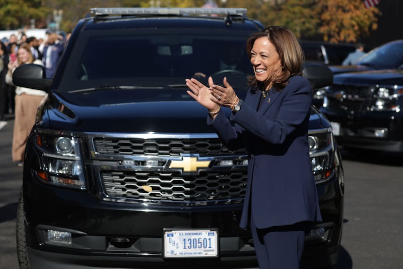 Vice President Kamala Harris greets staff as she returns to the White House.