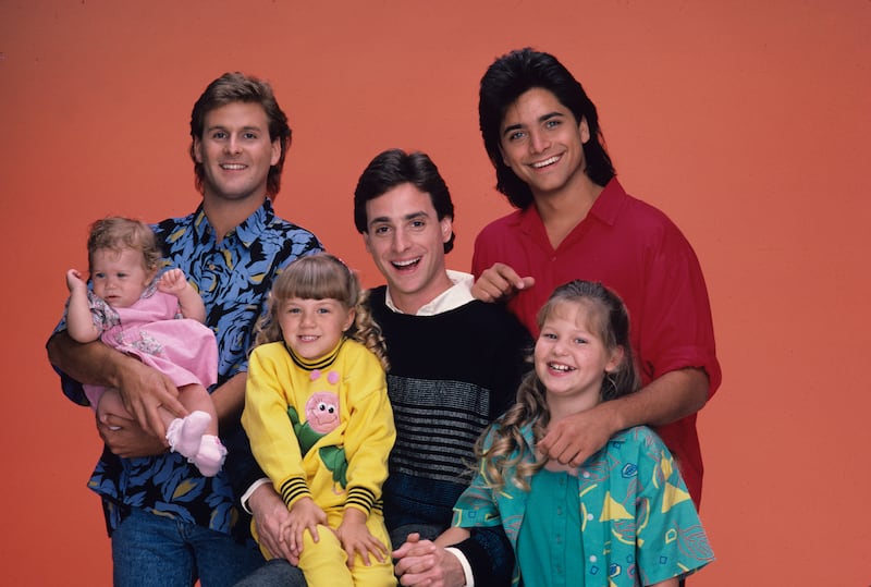 Bob Saget, Mary Kate/Ashley Olsen, Jodie Sweetin, Candace Cameron, Dave Coulier and John Stamos pose for the Full House season one cast portrait in 1987.