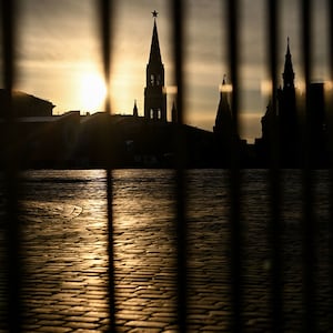 Kremlin tower through a fence on the empty Red Square in central Moscow