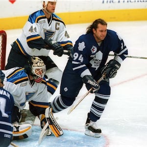 Toronto Maple Leaf forward Sergei Berezin, helmetless in front of the goal.