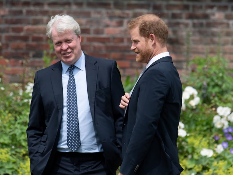 Prince Harry talks with his uncle Charles Spencer, 9th Earl Spencer, during the unveiling of a statue commissioned of his mother Diana, Princess of Wales, in the Sunken Garden at Kensington Palace, London, Britain July 1, 2021.