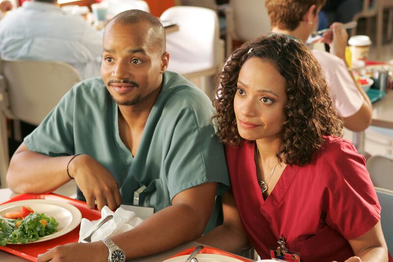 A photo still of Donald Faison and Judy Reyes in Scrubs