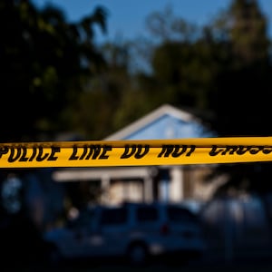 Police tape is put up in front of a California house.