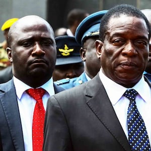 Acting Zimbabwe President Emmerson Mnangagwa (L) and his wife Auxilia (R) attend the funeral ceremony of Peter Chanetsa at the National Heroes Acre in Harare, on Jan. 7, 2017