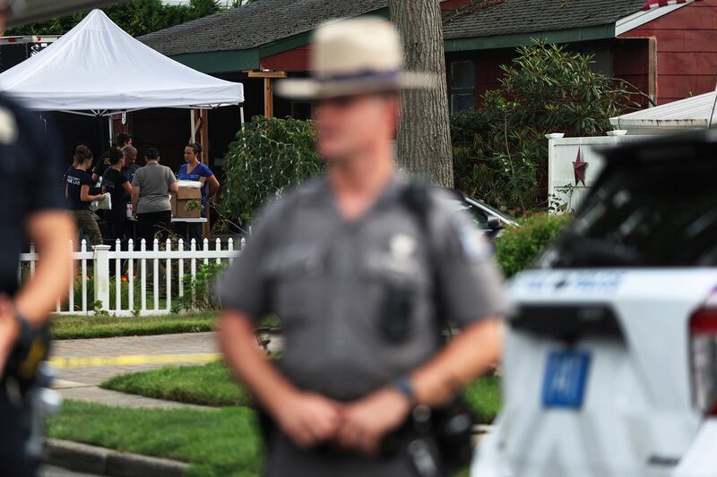 Crime scene investigators at the residence of architect Rex A. Heuermann.