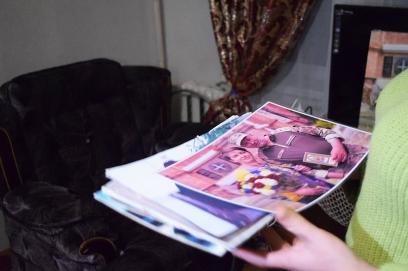 Yahupova shows a photograph from her wedding ceremony with her husband.