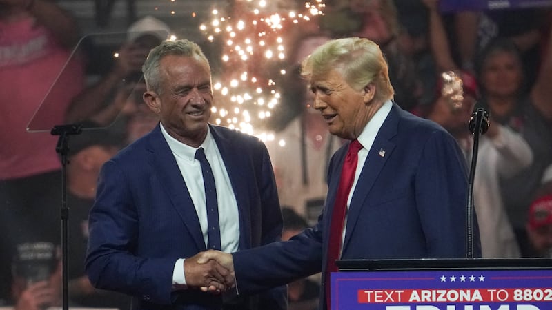 Donald Trump and Robert F. Kennedy Jr. shake hands on stage.