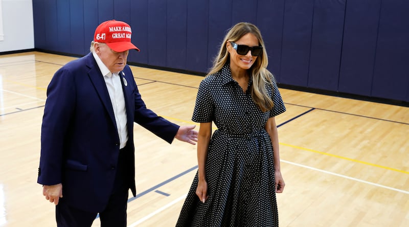 PALM BEACH, FLORIDA – NOVEMBER 5: Republican presidential candidate, former President Donald Trump, escorts his wife Melania Trump to the polls at the Morton and Barbara Mandel Recreation Center on Election Day, November 5, 2024 in Palm Beach, Florida. Trump will hold an election night event at the Palm Beach Convention Center. (Photo by Chip Somodevilla/Getty Images)