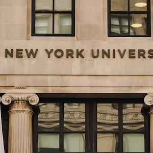 A view of New York University sign on the campus building.