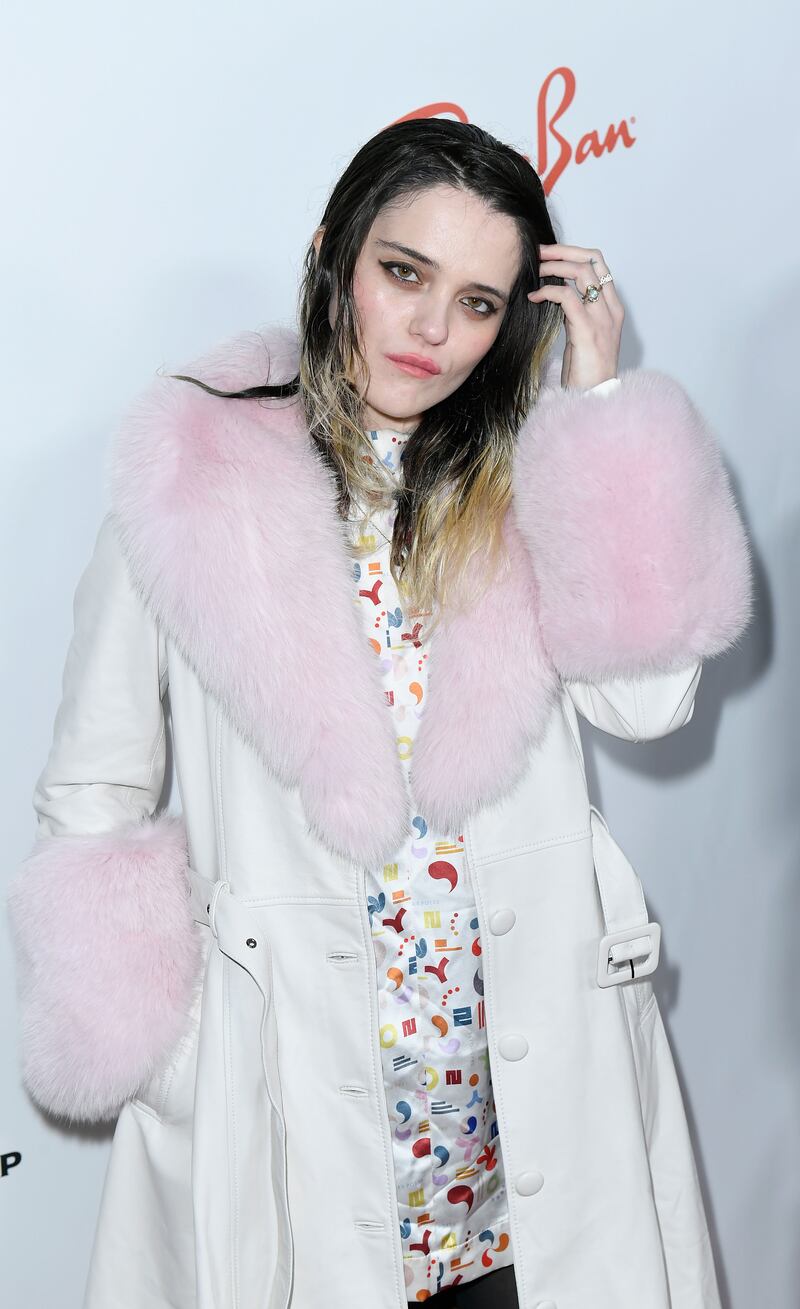 Sky Ferreira poses in front of a step and repeat.