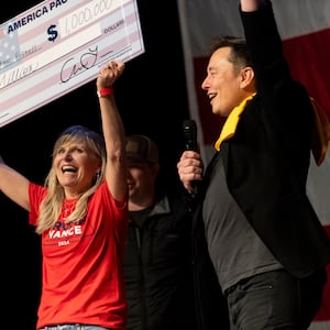 Elon Musk awards Kristine Fishell with a $1 million vanity check during a town hall in Pittsburgh, Pennsylvania.